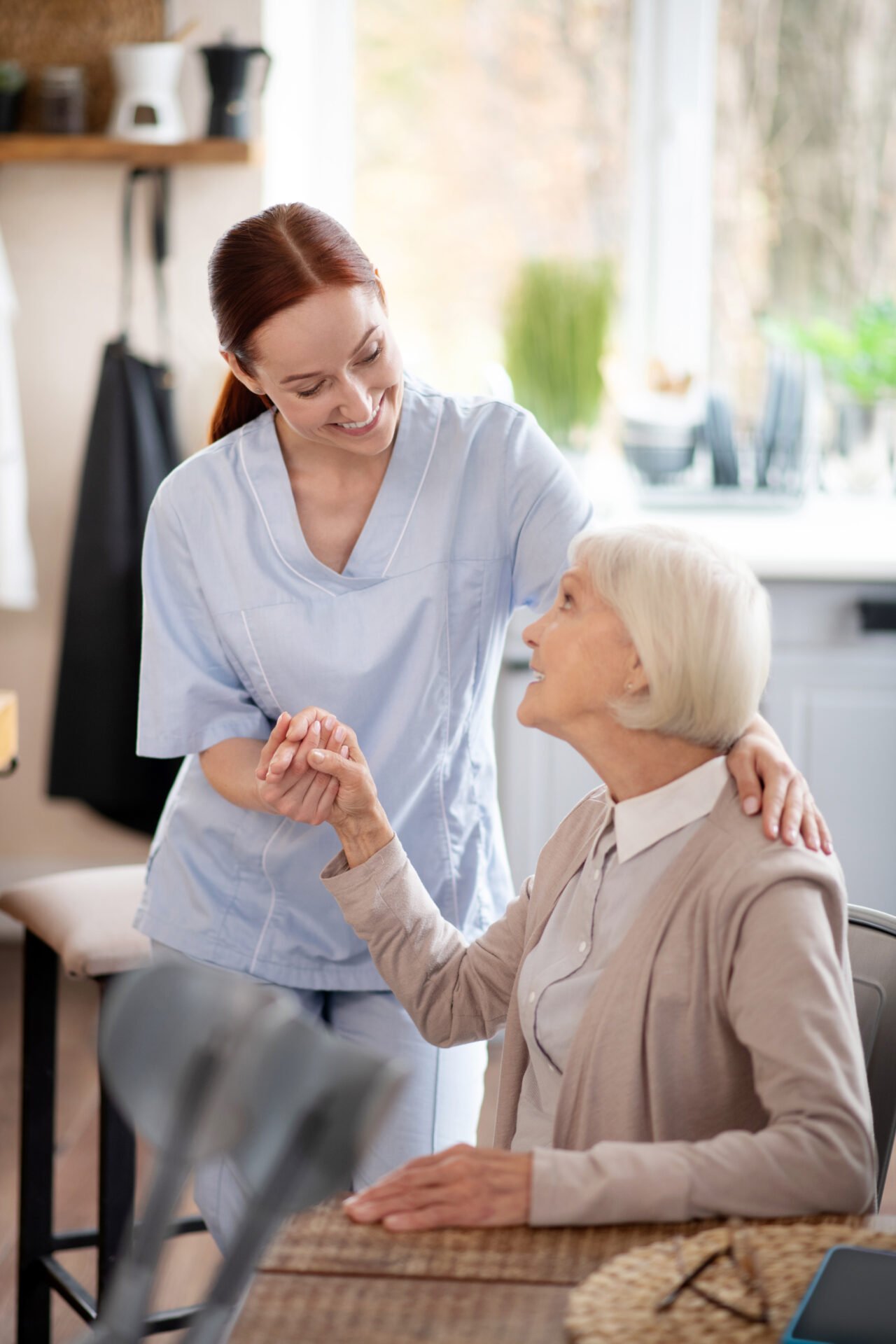 Caregiver supporting an older adult at home